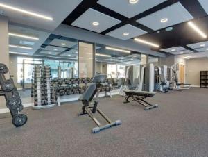 a gym with several treadmills and machines in a room at Southampton City Apartments by Charles Hope in Southampton