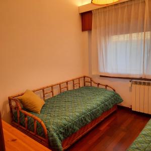 a bedroom with a wooden frame bed in a room at villa aremogna in Roccaraso