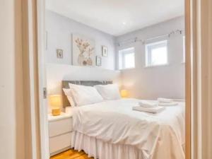 a bedroom with a white bed with two towels on it at Pass the Keys Contemporary Flat City Centre in Lincoln