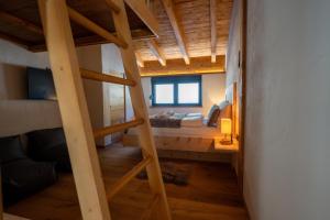 a room with a bunk bed and a ladder at Alprocks Alvaresort in Bichlbach