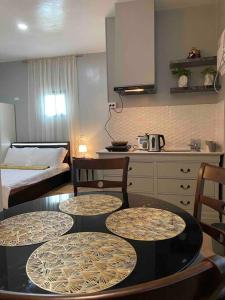 a room with a table and chairs and a kitchen at Balai ni Gemma – cozy studio near airport in General Santos