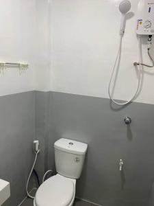 a bathroom with a toilet and a shower at Balai ni Gemma – cozy studio near airport in General Santos