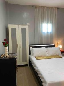 - une chambre avec un grand lit blanc et une fenêtre dans l'établissement Balai ni Gemma – cozy studio near airport, à General Santos