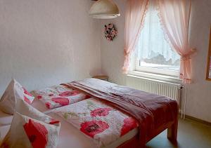 a bedroom with two beds in front of a window at Gasthof und Eiscafe Frank in Leimbach