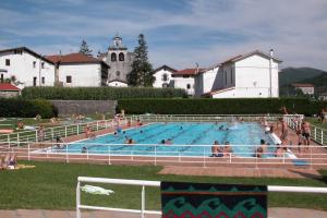 a large swimming pool with many people in it at Aizalegia in Igantzi