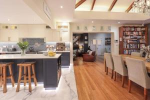 a kitchen and living room with a table and chairs at Onrus Beach House in Hermanus