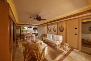 a living room with a couch and a table at Cayo Levantado Resort - All Inclusive in Santa Bárbara de Samaná