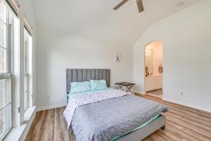 a white bedroom with a bed and a bathroom at Spacious Frisco Family Home Fenced Yard and Office! in Frisco