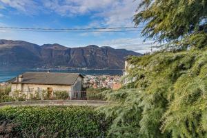 uma casa com vista para a água e as montanhas em Villa Claudia em Mandello del Lario