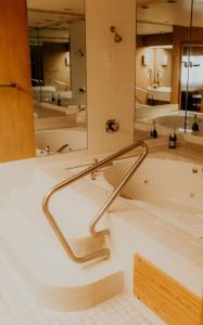 a bath tub in a bathroom with a large mirror at Wallace Inn in Wallace