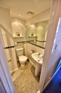 a bathroom with a toilet and a sink at Burnside Guest House in Ayr