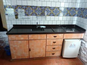 a kitchen counter with a sink and a stove at Hotel Mosteiro - Retiro e Recolhimento in Brotas