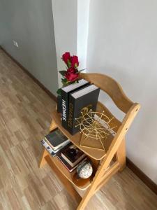 a table with books and flowers on a chair at Balai ni Atan - relaxing studio unit near airport in General Santos