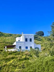 a white house on top of a hill at Villa Keroula in Alinda