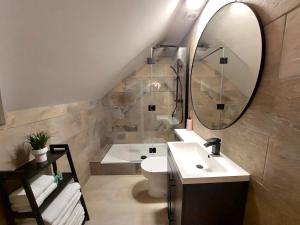 a bathroom with a sink and a toilet and a mirror at The Gallery - Bournemouth Town Centre - Beach 5 Minute Walk - Superfast WiFi - Outdoor Terrace - Sleeps 6 - Netflix - Contractor Friendly - Long Stay Rates - Coffee Machine in Bournemouth +18 photos