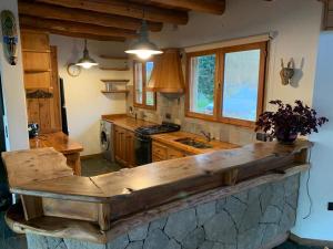 a kitchen with a wooden counter top in a room at Casa con costa del lago in Dina Huapi