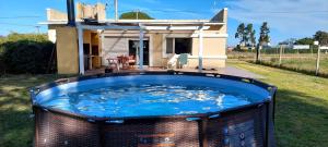 a large hot tub in front of a house at Home Beach Chapadmalal in Chapadmalal +4 photos