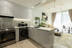 a kitchen with a washer and dryer in a room at Amazing Pool View In 1br Apt - Jvc Dubai in Dubai