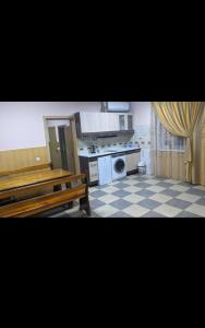 cocina con mesa y bancos en una habitación en Relax House Downtown !!! en Bălţi