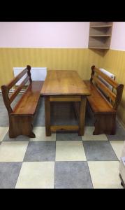 a wooden table and benches sitting next to each other at Relax House Downtown !!! in Bălţi