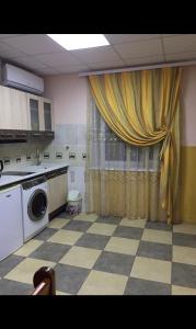 a laundry room with a washer and a curtain at Relax House Downtown !!! in Bălţi
