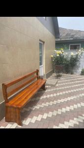 un banco de madera sentado frente a un edificio en Relax House Downtown !!!, en Bălţi