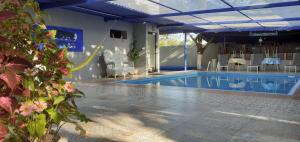 a large swimming pool with chairs and a table at The Blue Eco Lodge in Valladolid