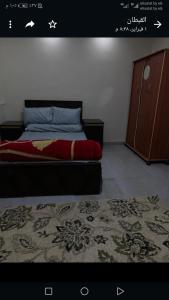 a bedroom with a bed and a dresser and a rug at المعادى. ميدان الجزائر.رقم 3.شقة 6 in Cairo