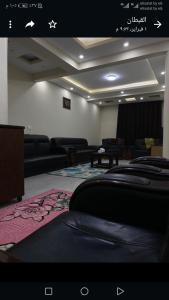 a living room with black couches and a rug at المعادى. ميدان الجزائر.رقم 3.شقة 6 in Cairo