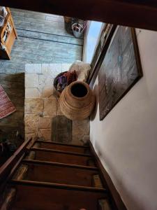 an overhead view of a stairs with a painting on the wall at Traditional farmhouse in Alexandros