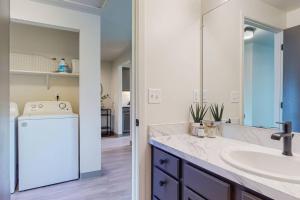 a bathroom with a sink and a washer and dryer at Modern Lofts at Aria 6 in Kalispell +28 photos