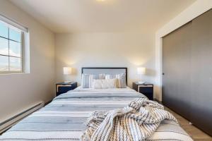 a bedroom with a large bed with two night stands at Modern Lofts at Aria 6 in Kalispell