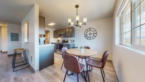 a kitchen and dining room with a table and chairs at Modern Lofts at Aria 6 in Kalispell