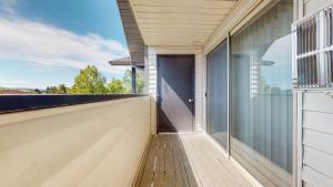 a balcony with a door on the side of a house at Modern Lofts at Aria 6 in Kalispell
