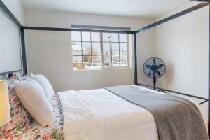 a bedroom with a bed with a fan and a window at Modern Lofts at Aria 1 in Kalispell