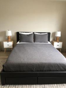 a bedroom with a bed with two nightstands and two lamps at Modern Lofts At Aria 8 in Kalispell