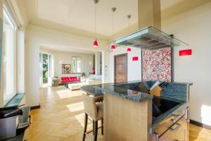 a kitchen with a counter top and a living room at Villa Sorrentina in Villefranche-sur-Mer
