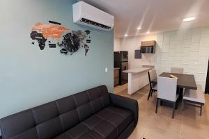 a living room with a couch and a clock on the wall at Dream Lagoons Veracruz in Veracruz