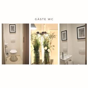 a bathroom with a toilet and a vase of flowers at Ruh-Ut in Wyk auf Föhr