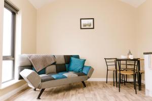 a living room with a couch and a table at Easkey Glamping Village in Easkey