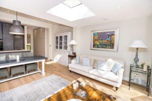 a living room with a white couch and a table at Swanky London pad in Putney in London