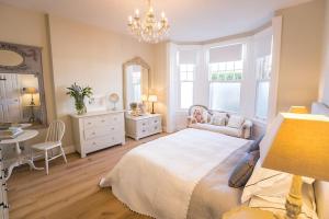 a bedroom with a bed and a table and a mirror at Swanky London pad in Putney in London