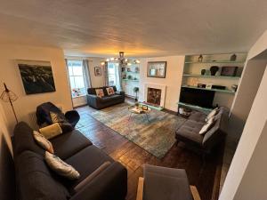 a living room with two couches and a fireplace at Seafront Apartment with Garden in Brighton & Hove