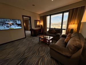 a living room with a couch and a tv at Al Safwah Hotel Third Tower in Makkah