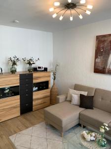 a living room with a couch and a entertainment center at Ferienwohnung Janus Altstadt-Hameln Haus 1 inklusive Parkplatz mit und ohne Balkon in Hameln