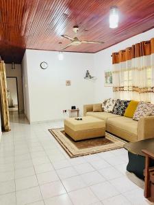 a living room with a couch and a table at Breeze Blows- Solitude Holiday Home in Matara