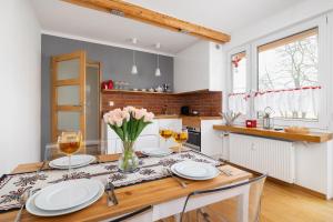 a kitchen with a table with glasses of wine at Comfortable Apartment Chramcówki in the Centre of Zakopane by Renters in Zakopane