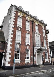 a large brick building on a city street at The Castle Hotel Wetherspoon in Ruthin