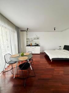 a room with a table and chairs and a bed at Central Haven Studio in Bucharest +11 photos