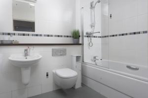 a bathroom with a toilet and a sink and a shower at Bathsheba, Ocean 1 in Newquay +16 photos